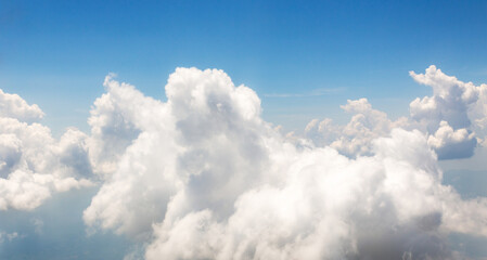 Image of white beautiful clouds above blue sky style of realistic atmospheres, aerial view