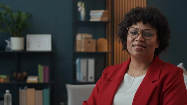 Medium copy space portrait of confident female African American psychologist in formalwear working at office