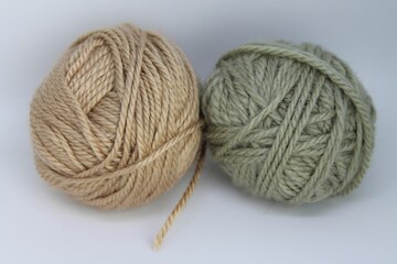 Two beautifully textured yarn balls showcasing earthy tones and soft fibers in a cozy crafting space, perfect for knitting and crocheting enthusiasts all year round