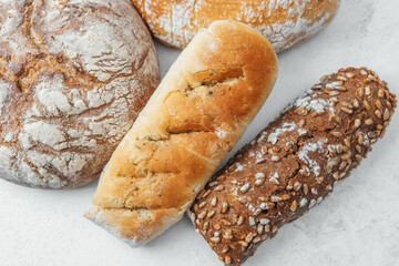 Assorted fresh breads arranged on a light background at a bakery
