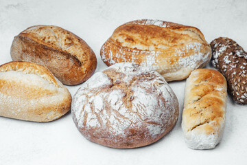 Freshly baked artisan bread assortment on white background for a bakery display