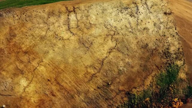 Aerial view of expansive earthy terrain with patchwork patterns