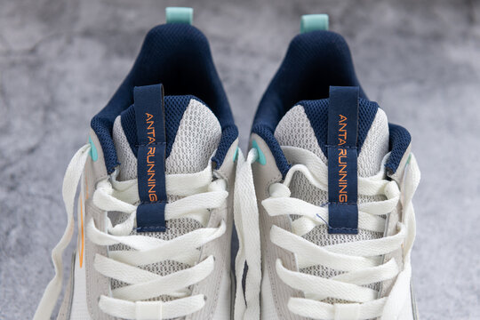 London. UK- 04.25.2025.The company brand name on a pair of running shoes by the Chinese sports equipment multinational corporation Anta Sports Products Limited.