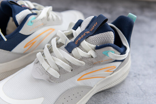 London. UK- 04.25.2025.The name and logo on a pair of running shoes by the Chinese sports equipment multinational corporation Anta Sports Products Limited.