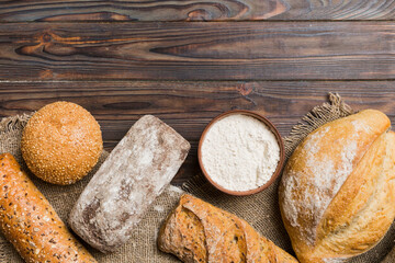 Homemade natural breads. Different kinds of fresh bread as background, top view with copy space