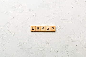 lupus word written on wood block. lupus text on table, concept