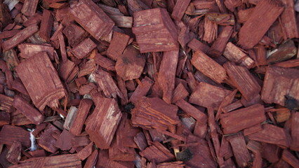Red decorative wood chips background for flower beds