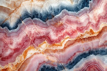 Stunning image of colorful onyx stone with wavy, layered patterns in pink, red, blue, and gold hues.