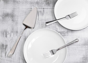 White plates and forks on a tabletop