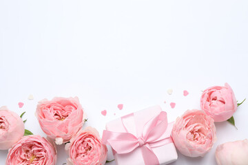 Beautiful pink peony roses with gift box on white background