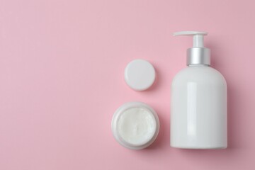 Natural cosmetic products on a pink background, top view