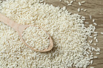 Raw brown rice in wooden spoon on the table