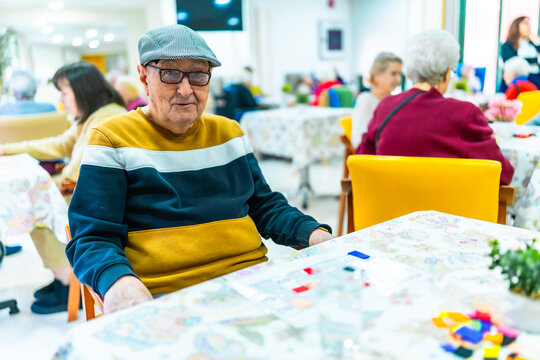 Elderly man enjoying recreational activities in nursing home