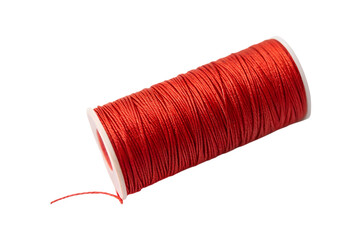 Close up of a vibrant spool of red thread with white ends transparent background