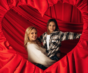 Mother's day, mom and daughter in heart shaped decorated room