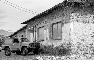 old abandoned car and house, black and white