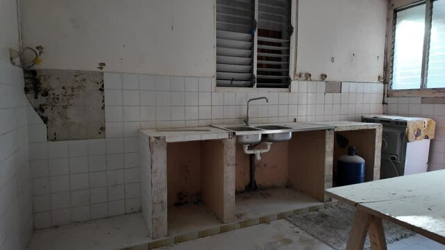 Handheld shot of kitchen in urgent need of renovation