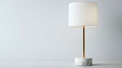 Marble base table lamp with brass arm and white shade on white background.