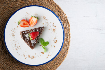 Chocolate cheesecake with fresh strawberries. Top view table.