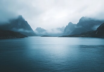 Serene Landscape of Misty Mountains and Calm Waters Under Overcast Sky Captured in Tranquil Nordic Scene