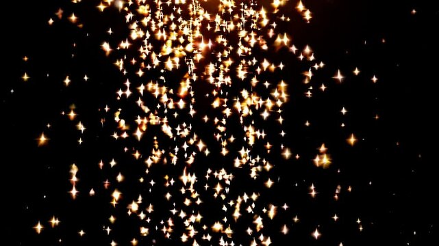 Golden sparks cascade against a black background. Shimmering particles of light, a festive and celebratory atmosphere. Luxury and celebration