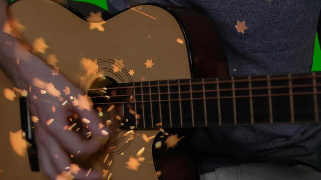 Flat design acoustic guitar being strummed in close-up scene, with golden star bokeh