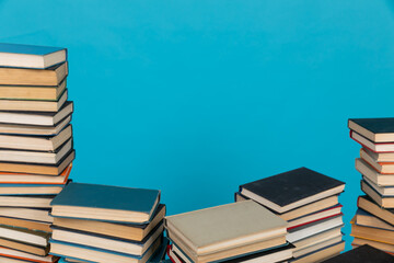 Stacks of books on the blue background of the university library