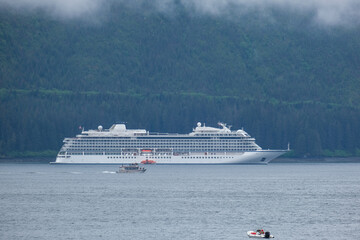 Luxury cruiseship cruise ship liner Orion and kayaks boat in Hoonah Icy Strait Point Bay, Alaska...