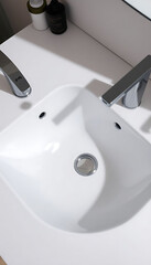 Fototapeta premium white bathroom sink sitting on top of a white counter