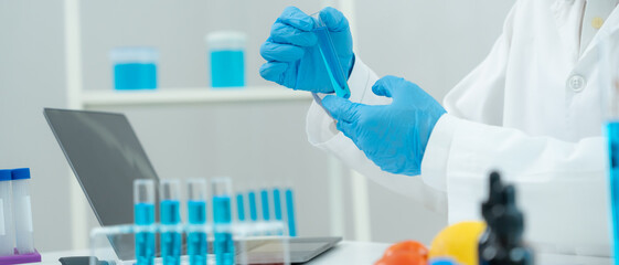 Scientist check chemical food residues in laboratory. Control experts inspect quality of vegetables...