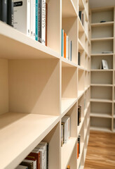 Fototapeta premium bookshelf filled with lots of books on top of a hard wood floor