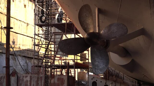  Propeller of ship. Fixed pitch propeller. Vessel ashore on ship repairing yard. Propeller Installation. 