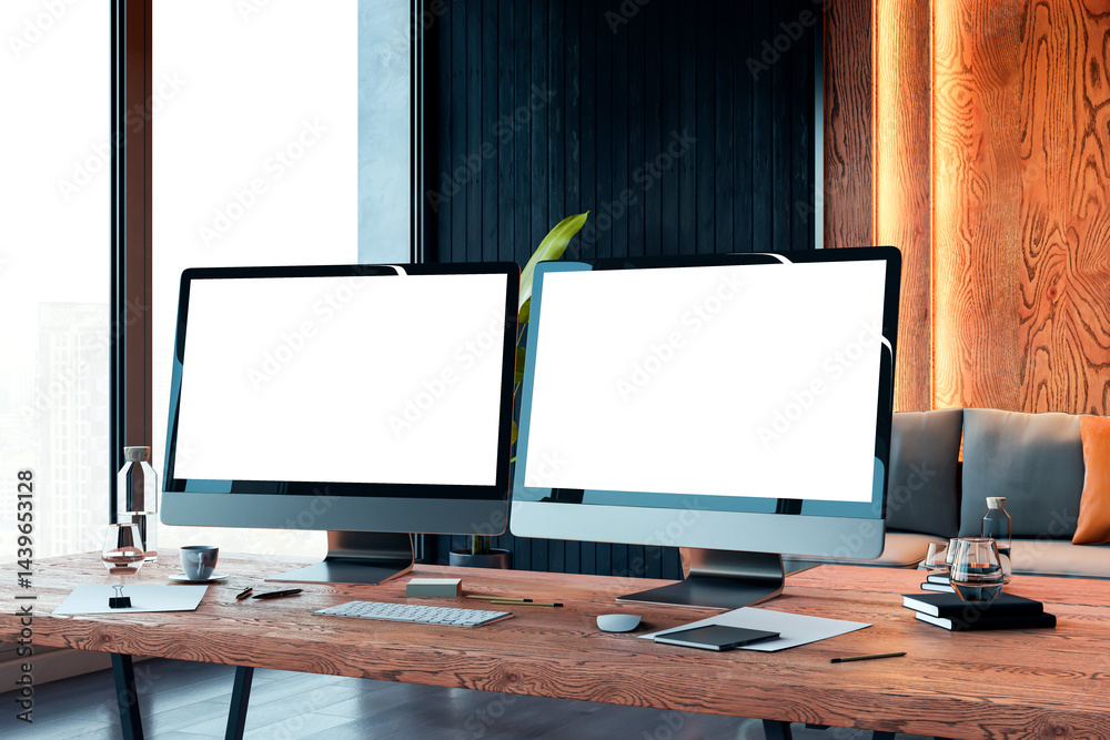 Poster two blank computer monitors on wooden desk in modern office interior with city view and cozy lightin