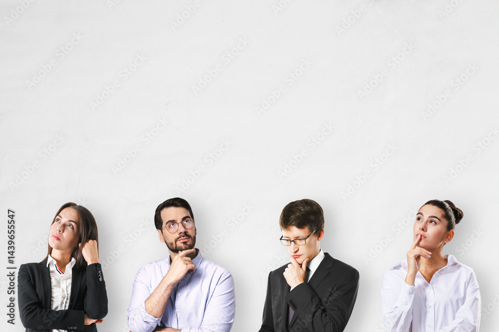 Aufkleber group of thoughtful business people looking up against light background with copy space, concept of 