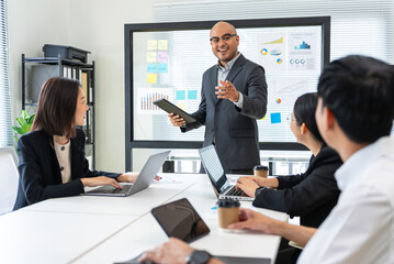 Happy diverse group Asian business team analyzing statistics financial. Group Team of business people meeting conference discussion various topic corporate concept in office.