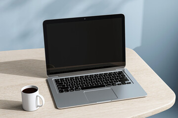Fototapeta premium Modern laptop and coffee cup on wooden desk in sunlight with soft shadows on blue background, simple workspace concept for business and technology. 3D Rendering