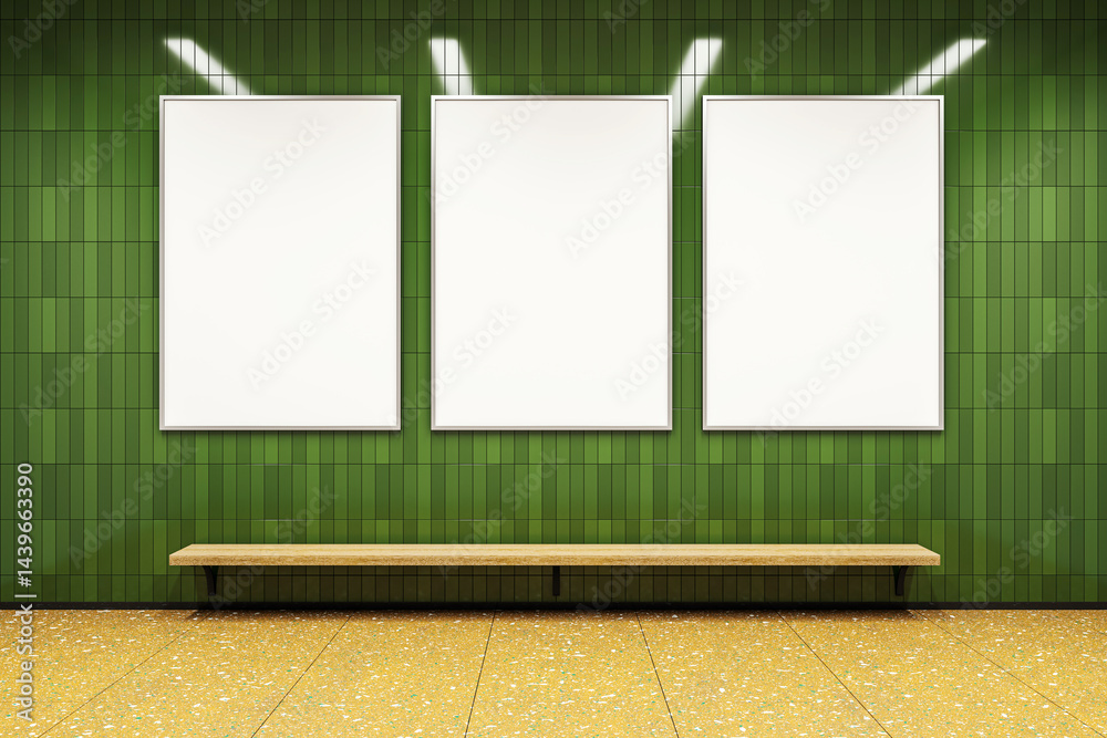 Poster three vertical blank poster frames on green tiled wall above wooden bench in subway corridor with te
