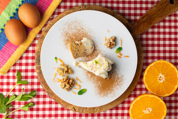 Carrot and walnut cake with cream cheese frosting. Top view table.