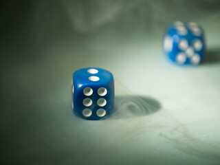 Blue dice on bokeh background