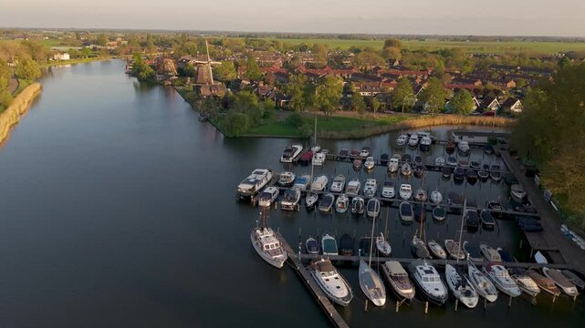 Aerial view of river Vecht, marina and historical windmills in dutch city of Weesp