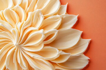 Fototapeta premium Elegant cream frosting design on a coral background.