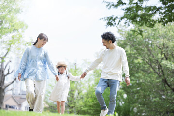 Image of spring and summer outings and outdoor recreation with families walking hand in hand with smiles on their faces Full body