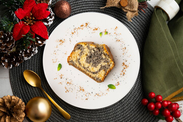 Delicious lemon and poppy seed cake. Top view table with christmas decorations.