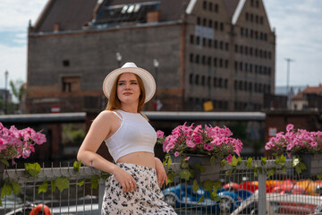 Fototapeta premium girl in a white hat on the background of the city of Gdansk Poland Europe
