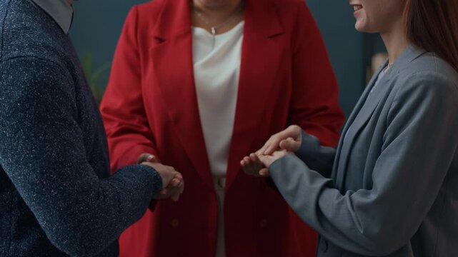Zoom out shot of Caucasian couple undergoing therapy of relationship, talking to female African American psychologist