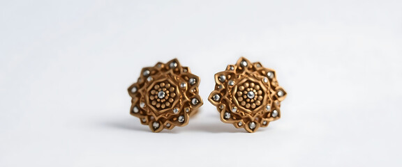 pair of gold and diamond earrings on a white background