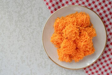 Crispy Foi Thong in ceramic plate ,Foi Thong is made from farm duck eggs.