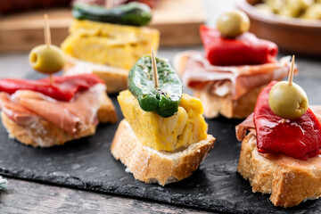 Traditional Spanish pintxos on wooden table