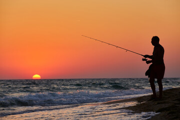 Silhouette of Fisherman at Sunset
