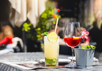 Summer cool drink of Homemade Sangria,Mojito lemonade, lemon mint on wooden table.Refreshing of organic summer soda drink, punch red berry, strawberry cocktail with iced for holiday vacation 
